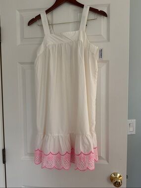 White dress with embroidered pineapple trim